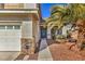 Front entry of a house with teal door and walkway at 2374 Thayer Ave, Henderson, NV 89074