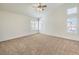 Spacious main bedroom with high ceilings, ceiling fan, and carpet flooring at 2374 Thayer Ave, Henderson, NV 89074