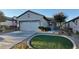 Single story house with a two-car garage, and well-manicured lawn at 2575 Red Planet St, Henderson, NV 89044