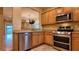 Well-equipped kitchen with stainless steel appliances and oak cabinets at 2575 Red Planet St, Henderson, NV 89044