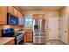 Modern kitchen featuring stainless steel appliances and wood cabinets at 2575 Red Planet St, Henderson, NV 89044