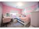 Pink bedroom with a geometric accent wall and vanity at 264 Bella Matese Ave, Las Vegas, NV 89183