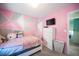 Bedroom with a geometric pink and grey accent wall at 264 Bella Matese Ave, Las Vegas, NV 89183