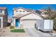 Two-story house with a two-car garage and a blue front door at 264 Bella Matese Ave, Las Vegas, NV 89183