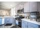 Modern kitchen with stainless steel appliances and white quartz countertops at 264 Bella Matese Ave, Las Vegas, NV 89183