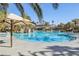 Large community pool with palm trees and umbrellas at 266 Cullerton St, Las Vegas, NV 89148