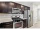 Kitchen with stainless steel appliances and dark brown cabinets at 266 Cullerton St, Las Vegas, NV 89148