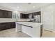 Modern kitchen featuring an island, stainless steel appliances, and dark cabinetry at 266 Cullerton St, Las Vegas, NV 89148