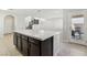 Kitchen island with white countertops and dark brown cabinets, open to living area at 266 Cullerton St, Las Vegas, NV 89148