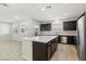 Spacious kitchen with an island, stainless steel appliances, and dark brown cabinets at 266 Cullerton St, Las Vegas, NV 89148