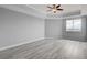 Bright bedroom with ceiling fan, large window, and gray walls at 27 E Agate Ave # 505, Las Vegas, NV 89123