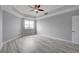 Bright bedroom with ceiling fan and gray walls and wood-look flooring at 27 E Agate Ave # 505, Las Vegas, NV 89123