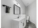 Clean bathroom with white vanity and dark-grey flooring at 308 Belfast St, Henderson, NV 89015