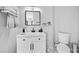 Bathroom with white vanity, toilet, and stylish mirror at 308 Belfast St, Henderson, NV 89015