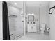 Modern bathroom with walk-in shower, white vanity, and marble-look tile at 308 Belfast St, Henderson, NV 89015