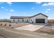 Modern single story home with a large driveway and desert landscaping at 308 Belfast St, Henderson, NV 89015