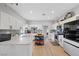 Modern kitchen with white cabinets, quartz countertops, and an island at 308 Belfast St, Henderson, NV 89015