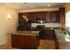 Spacious kitchen with dark wood cabinets and granite countertops at 3309 Conterra Park Ave, North Las Vegas, NV 89081