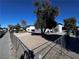 Backyard of a two-story building with a fence and tree at 3370 Athens St, Las Vegas, NV 89169