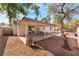 Backyard with covered patio, gravel landscaping, and trees at 3378 Del Marino St, Las Vegas, NV 89121