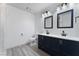 Bathroom with double vanity, navy blue cabinets, and white countertop at 3378 Del Marino St, Las Vegas, NV 89121