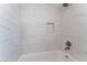 Bathroom with white marble-look tile and a bathtub at 3378 Del Marino St, Las Vegas, NV 89121