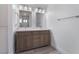 Clean bathroom with a double vanity and gray wood cabinets at 3378 Del Marino St, Las Vegas, NV 89121