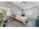 Cozy bedroom with gray walls, wood-look flooring, and a striped comforter set at 3378 Del Marino St, Las Vegas, NV 89121