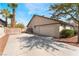 Two-car garage with a concrete driveway and side yard at 3378 Del Marino St, Las Vegas, NV 89121