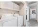 Laundry room with washer, dryer, and overhead cabinets at 3378 Del Marino St, Las Vegas, NV 89121