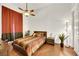 Bedroom with hardwood floors, ceiling fan, and orange curtains at 385 Apple River Ct, Las Vegas, NV 89148