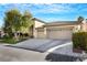 Single-story home with two-car garage and landscaped front yard at 385 Apple River Ct, Las Vegas, NV 89148