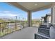 Relaxing balcony featuring black metal railing, two stylish chairs, and views of the nearby mountains at 43 Strada Loreto, Henderson, NV 89011