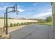 Community basketball court next to a manicured lawn and a desert landscape at 43 Strada Loreto, Henderson, NV 89011