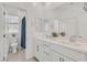 Bright bathroom with double vanity, modern fixtures, large mirror, and a separated toilet area at 43 Strada Loreto, Henderson, NV 89011