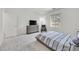 Inviting bedroom featuring a comfortable bed, modern dresser, and a large window with natural light at 43 Strada Loreto, Henderson, NV 89011