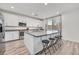 Modern, updated kitchen with white cabinets, a large island with seating, and stainless steel appliances at 43 Strada Loreto, Henderson, NV 89011