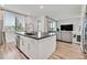 Open kitchen concept featuring an island with a stainless steel dishwasher and a view of the living room at 43 Strada Loreto, Henderson, NV 89011