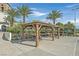 Outdoor seating area featuring tables and chairs under wooden pergolas, perfect for community gatherings and picnics at 43 Strada Loreto, Henderson, NV 89011