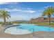 Resort-style community pool featuring walk-in entry, palm trees, and mountain views at 43 Strada Loreto, Henderson, NV 89011