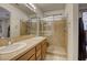 Bathroom with double vanity, shower, and tiled floor at 4412 Desert Park Ave, North Las Vegas, NV 89085