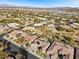 Aerial view showcasing a neighborhood's homes, landscaping, and distant city views at 4618 Atlantico St, Las Vegas, NV 89135