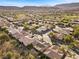 Aerial view of homes in a community with a golf course and mountain backdrop at 4618 Atlantico St, Las Vegas, NV 89135