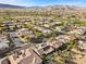 Aerial view of a luxury community with houses, golf course, and mountains in the background at 4618 Atlantico St, Las Vegas, NV 89135