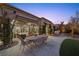 Covered patio with seating area, lush landscaping, and putting green at 4618 Atlantico St, Las Vegas, NV 89135