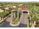 Gated community entrance with lush landscaping and flagpoles at 4618 Atlantico St, Las Vegas, NV 89135