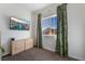 Bedroom with large window and TV at 4911 E Parkwood Dr, Pahrump, NV 89061