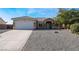 Single-story house with a two-car garage and gravel landscaping at 4911 E Parkwood Dr, Pahrump, NV 89061