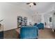 Bright living room with teal couches, a bookcase, and carpeting at 4911 E Parkwood Dr, Pahrump, NV 89061