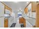 Bright kitchen featuring wood cabinets, ample counter space, and a breakfast bar at 513 Rafkin Pl, Henderson, NV 89052